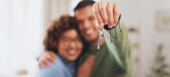 A couple holding the keys to their new home. 