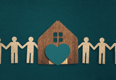 Cut out people holding hands with a house in the middle with a heart on the house.